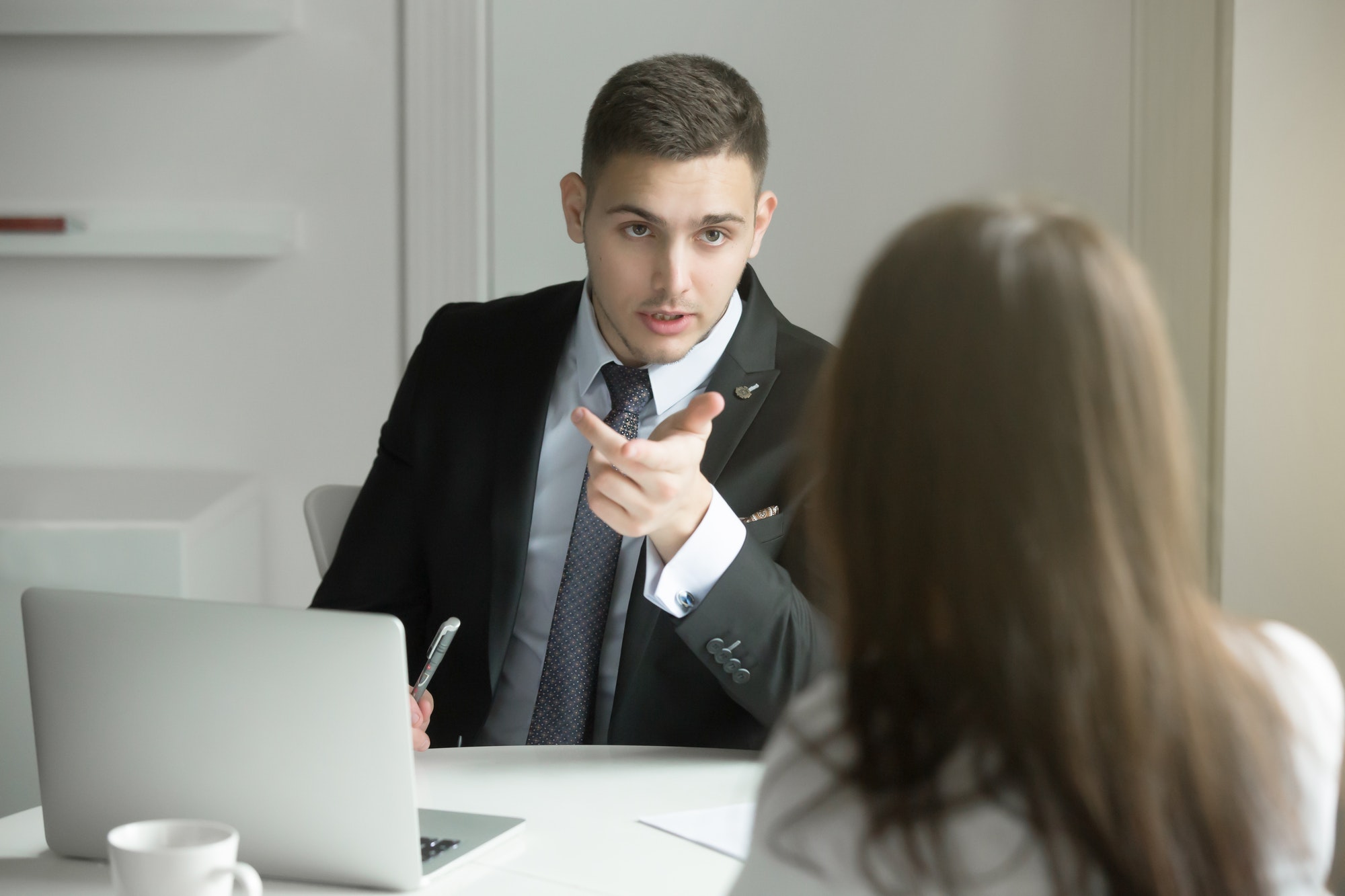 two-business-people-talking-at-the-office-desk.jpg